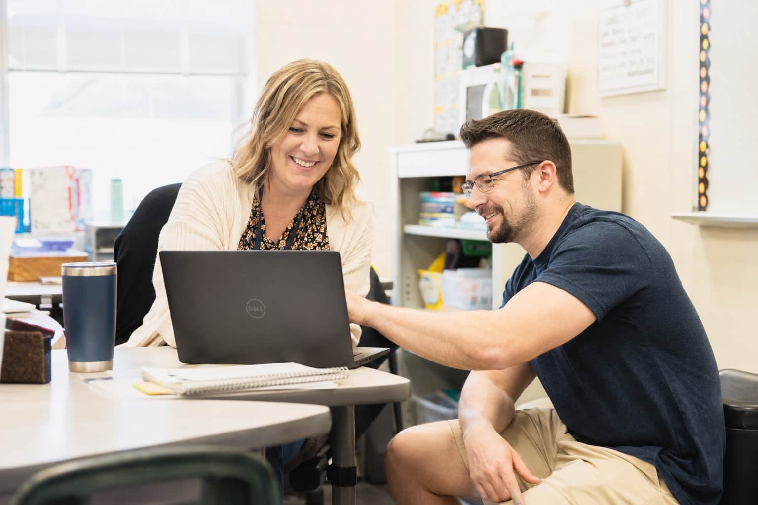 Suzor IT technician helping a town clerk at her counter workstation