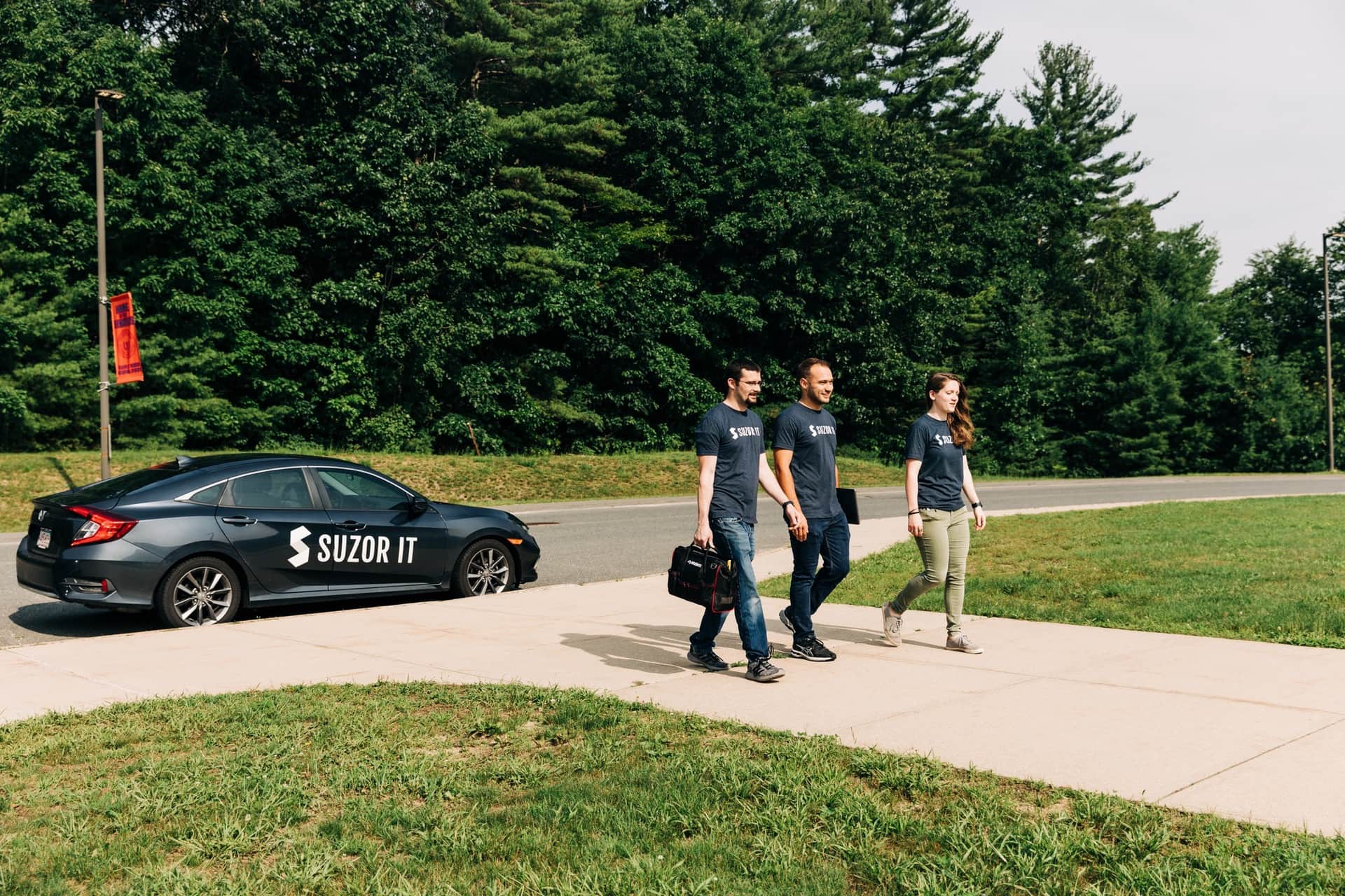 Suzor IT technicians arriving on site with a branded company car